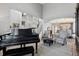 Elegant living space with a piano, and an open view to the dining area at 5207 Denim Ct, Parker, CO 80134