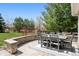 Covered patio area featuring a gray table and seating for six, overlooks expansive lawn at 5207 Denim Ct, Parker, CO 80134