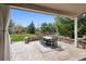 Covered patio area featuring a gray table and seating for six, perfect for outdoor dining at 5207 Denim Ct, Parker, CO 80134
