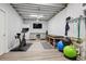 Spacious workout area with exercise bike, massage table, and TV at 5207 Denim Ct, Parker, CO 80134