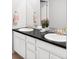 Modern bathroom featuring a dual vanity with black countertop and bronze fixtures, complemented by stylish decor at 500 176Th Ave, Broomfield, CO 80023