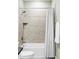 Clean bathroom design with neutral tile shower, white tub, and updated fixtures at 500 176Th Ave, Broomfield, CO 80023