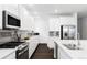 Modern kitchen features stainless steel appliances, sleek white cabinets and subway tile backsplash at 500 176Th Ave, Broomfield, CO 80023