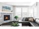 Living room showcasing dark wood flooring, corner fireplace, and large windows at 500 176Th Ave, Broomfield, CO 80023