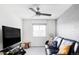 Comfortable living room with a leather sofa, large television, and contemporary ceiling fan at 500 176Th Ave, Broomfield, CO 80023