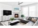 Living room featuring stone fireplace, mantel, dark hardwood floors, and large windows for natural light at 500 176Th Ave, Broomfield, CO 80023