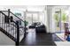 Bright living room with dark hardwood floors, a corner fireplace, large windows, and access to an outdoor patio at 500 176Th Ave, Broomfield, CO 80023