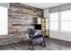 Modern home office featuring decorative wood accent wall, sleek desk, and ample natural light from large windows at 500 176Th Ave, Broomfield, CO 80023