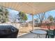 View of the backyard with covered patio area, outdoor furniture, and partial fencing at 14939 E Harvard Ave, Aurora, CO 80014