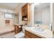 Bathroom boasts a sink, shower with glass door, and vanity with storage at 14939 E Harvard Ave, Aurora, CO 80014