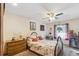 Comfortable bedroom with floral bedding, side tables, and a ceiling fan at 14939 E Harvard Ave, Aurora, CO 80014