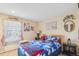 Bedroom with a cozy bed, floral accents, and a fireplace at 14939 E Harvard Ave, Aurora, CO 80014