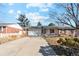 Charming single-story home featuring a spacious driveway and attached two-car garage at 14939 E Harvard Ave, Aurora, CO 80014
