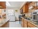 Bright kitchen featuring stainless steel appliances, granite countertops, and wooden cabinetry at 14939 E Harvard Ave, Aurora, CO 80014