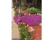 Landscaping featuring vibrant purple flowers, yellow flowers, and decorative statues at 14939 E Harvard Ave, Aurora, CO 80014
