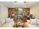 Bright living room featuring a brick fireplace and built-in bookshelves at 14939 E Harvard Ave, Aurora, CO 80014