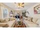 Bright living room flowing into the dining area with a view of the kitchen at 14939 E Harvard Ave, Aurora, CO 80014