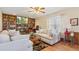 Bright living room featuring a brick fireplace and built-in bookshelves at 14939 E Harvard Ave, Aurora, CO 80014