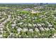 Aerial view of a neighborhood with tree-lined streets, rooftops, and community features at 85 Silver Fox Dr, Greenwood Village, CO 80121