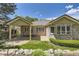 Brick home with an extended covered patio and well-maintained landscaped backyard at 85 Silver Fox Dr, Greenwood Village, CO 80121