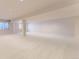 A carpeted basement rec room with white walls and ceilings with windows at 85 Silver Fox Dr, Greenwood Village, CO 80121