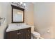 Bathroom vanity with a dark wood cabinet and white countertop with a modern faucet at 85 Silver Fox Dr, Greenwood Village, CO 80121