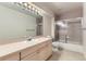 Bathroom with shower, tub, and a vanity with cabinets at 85 Silver Fox Dr, Greenwood Village, CO 80121