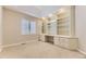 Bright bedroom featuring built-in shelving with cabinets and drawers, and carpet flooring at 85 Silver Fox Dr, Greenwood Village, CO 80121