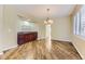 Dining room featuring a stylish chandelier, hardwood floors, and a built-in bar area at 85 Silver Fox Dr, Greenwood Village, CO 80121