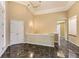 Foyer featuring dark marble flooring and a white half wall with an entry closet at 85 Silver Fox Dr, Greenwood Village, CO 80121
