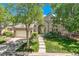 Charming brick home with an arched entry, well-manicured lawn, and mature trees at 85 Silver Fox Dr, Greenwood Village, CO 80121