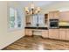 Bright kitchen nook with hardwood floors, built-in desk, cabinetry, and large windows with plantation shutters at 85 Silver Fox Dr, Greenwood Village, CO 80121