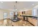 Open kitchen featuring an island with a gas cooktop, granite countertops, and stainless steel appliances at 85 Silver Fox Dr, Greenwood Village, CO 80121
