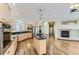 Spacious kitchen with stainless appliances, granite counters, hardwood floors, and an adjacent living area with a fireplace at 85 Silver Fox Dr, Greenwood Village, CO 80121