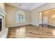 Elegant living room with hardwood floors, large windows, and a cozy fireplace at 85 Silver Fox Dr, Greenwood Village, CO 80121