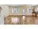 Open living area featuring hardwood floors, plantation shutters, and natural light with access to kitchen area at 85 Silver Fox Dr, Greenwood Village, CO 80121