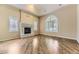 Bright living room featuring hardwood floors, a fireplace, and ample natural light at 85 Silver Fox Dr, Greenwood Village, CO 80121