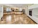 Spacious living area with fireplace, kitchen and living spaces that are connected by hardwood floors at 85 Silver Fox Dr, Greenwood Village, CO 80121