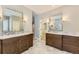 Spacious main bathroom featuring double vanity with marble counter tops and tiled floors at 85 Silver Fox Dr, Greenwood Village, CO 80121
