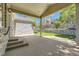 Covered patio with stone pillars, brick home, stone wall, and a lush lawn at 85 Silver Fox Dr, Greenwood Village, CO 80121