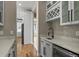 Wet bar area with wine storage, granite countertops, stainless steel appliances, and tile floors at 16250 Kenosha St, Brighton, CO 80603