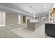 Spacious basement featuring modern lighting, staircase, marble floor, and bar area at 16250 Kenosha St, Brighton, CO 80603