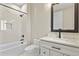 Bathroom with white marble tile, a tub-shower, a modern vanity, and matte black fixtures at 16250 Kenosha St, Brighton, CO 80603