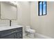 Stylish half bath with a modern vanity and tile flooring at 16250 Kenosha St, Brighton, CO 80603