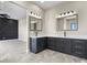 Modern bathroom featuring double sinks, a marble countertop, and decorative lighting fixtures at 16250 Kenosha St, Brighton, CO 80603