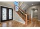 Bright foyer with hardwood floors, staircase, and elegant lighting at 16250 Kenosha St, Brighton, CO 80603