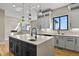 Open kitchen with stainless steel appliances, granite counters, island with sink, hardwood floors, and fireplace in view at 16250 Kenosha St, Brighton, CO 80603