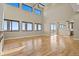 Open-concept living room with high ceilings and large windows at 16250 Kenosha St, Brighton, CO 80603