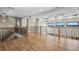 Open living space with hardwood floors and stylish railing overlooking the foyer at 16250 Kenosha St, Brighton, CO 80603