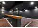 Stylish theater room with platform seating, dark walls, and unique lighting fixtures at 16250 Kenosha St, Brighton, CO 80603